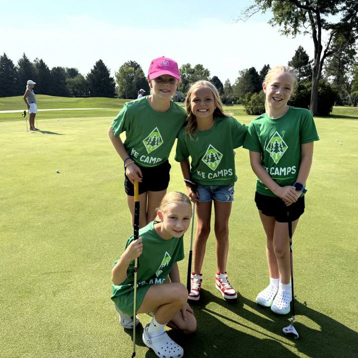 Campers on the putting green with a counselor