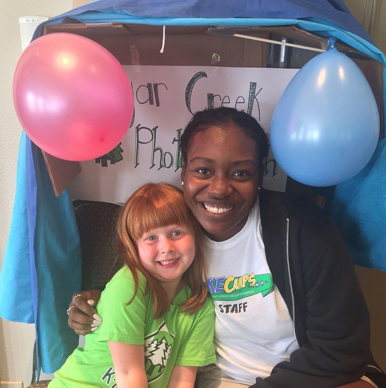 Counselor and camper smiling